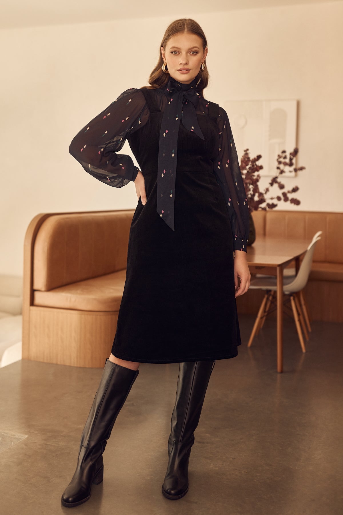 Black corduroy pinafore style apron dress with adjustable straps