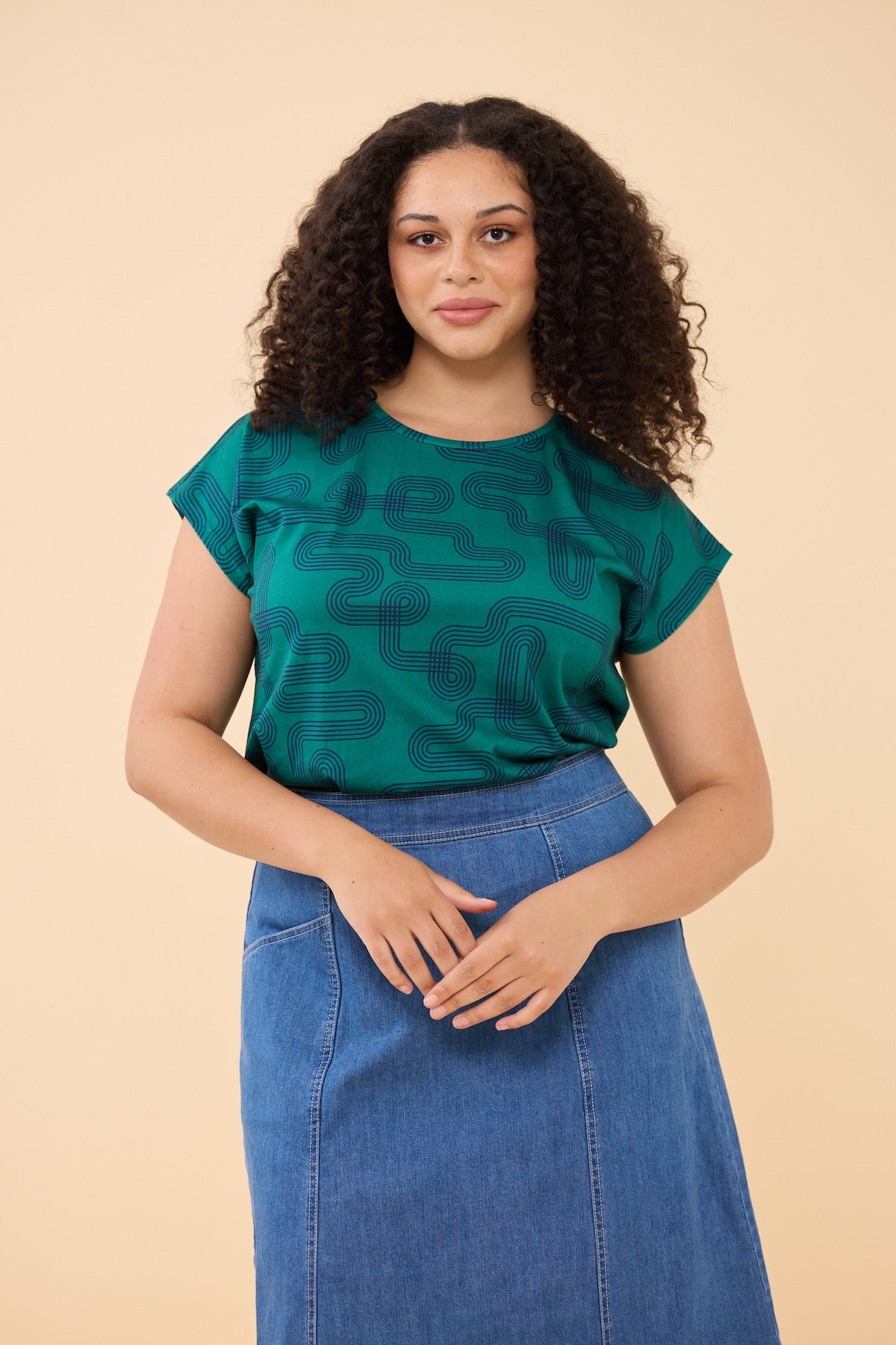 Woman wearing Frock Me Out LABYRINTH Capped Sleeve Tee with denim skirt